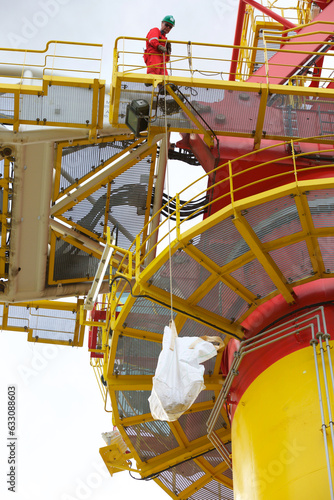 Worker sending down package from platform