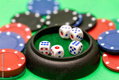 Fotografie Dice and casino chips on green baize table