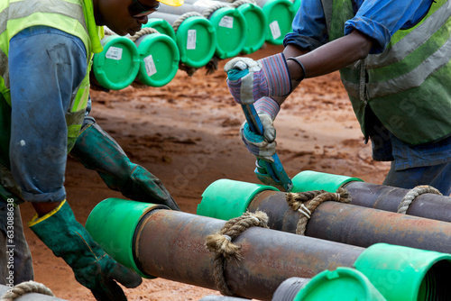 Two workers working with pipes photo