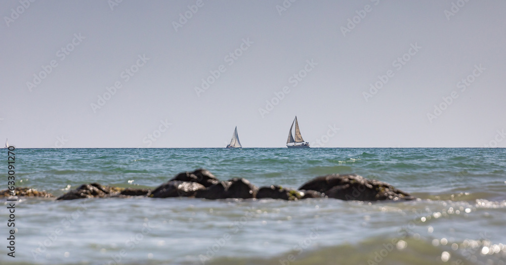 Two sailing ships at sea, with coastal cliffs in the foreground Two sailing ships at sea, with coastal cliffs in the foreground