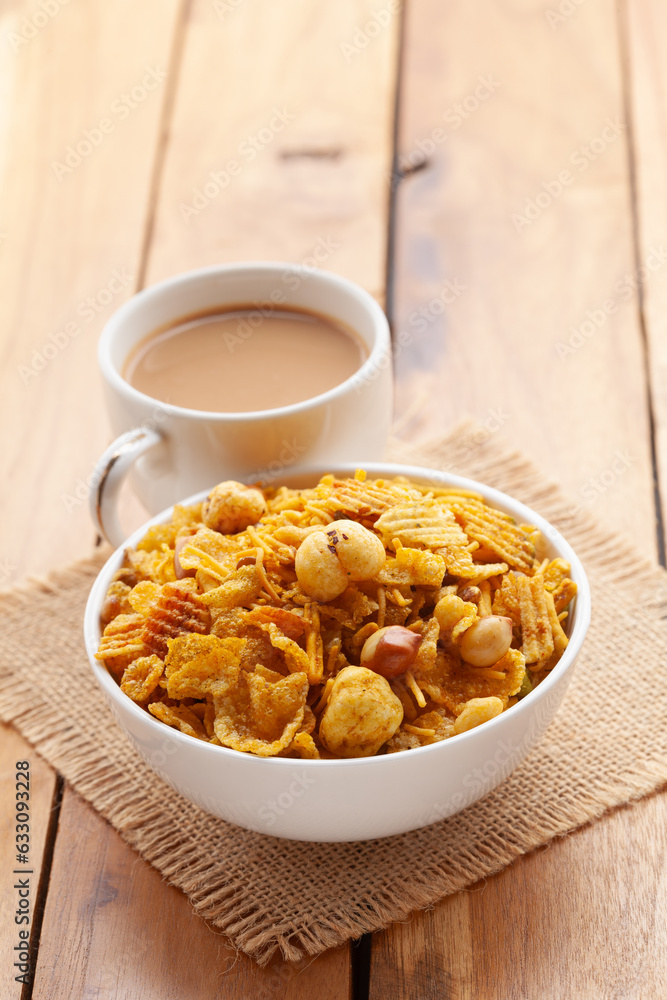 Close-Up of crunchy Indian mixture snacks with hot tea or Coffee. Studio shoot at a declined angle. Close-Up of crunchy Indian mixture snacks with hot tea or Coffee. Studio shoot at a declined angle.