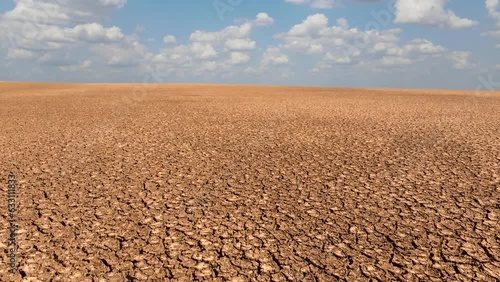 Cracked soil surface natural disaster - global warming. Drone shot of dried up lake, Drought - environmental damage, climate change