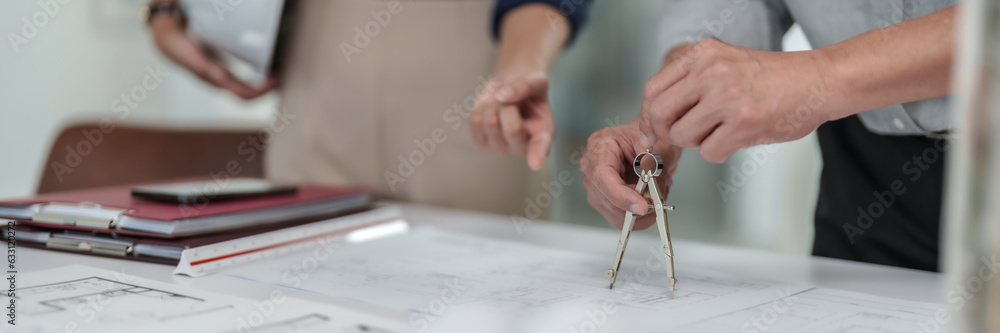 Obraz premium Interior architect working with blueprint planning in modern office, engineering concept. .