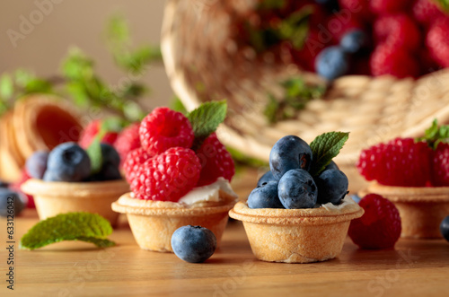 Small tartlets with fresh raspberries and blueberries.