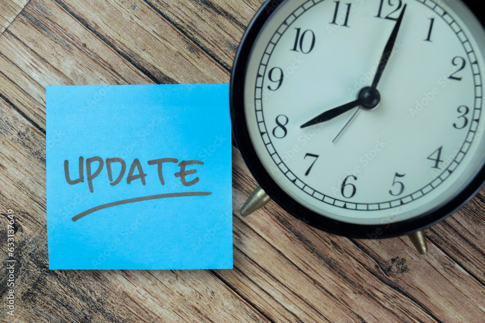 Concept of Update write on sticky notes isolated on Wooden Table. Concept of Update write on sticky notes isolated on Wooden Table.