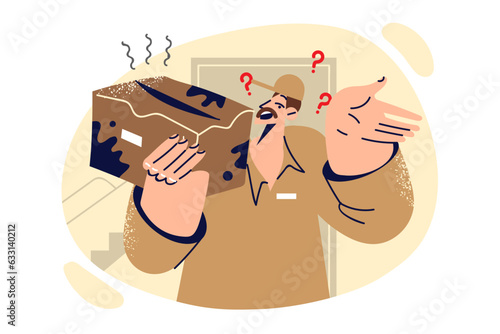 Damaged package in hands of man courier delivered broken product packed in dirty cardboard box