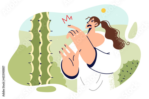 Woman pricked finger on cactus, touching needle and injuring herself walking in mexican desert.