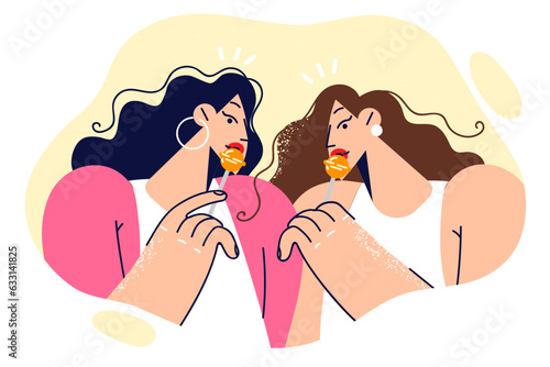 Twin girls with lollipops seductively eat sweets on stick and try to attract attention of men