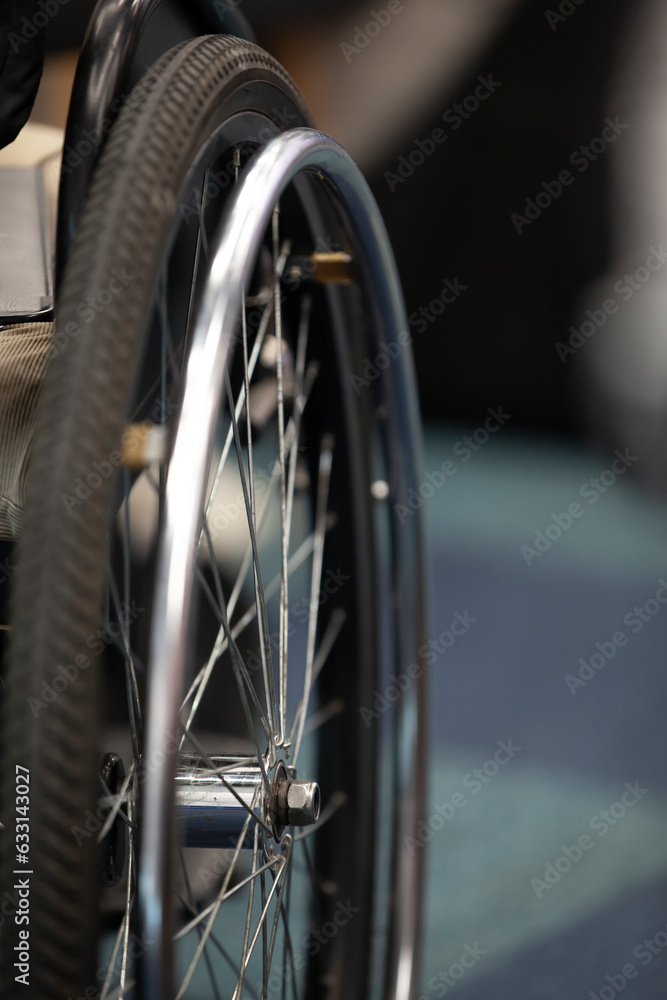 Wheelchair wheel, close-up, copyspace. The concept of inclusion.
