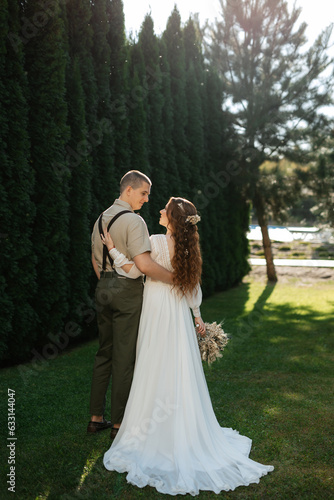 wedding walk of the bride and groom in a coniferous