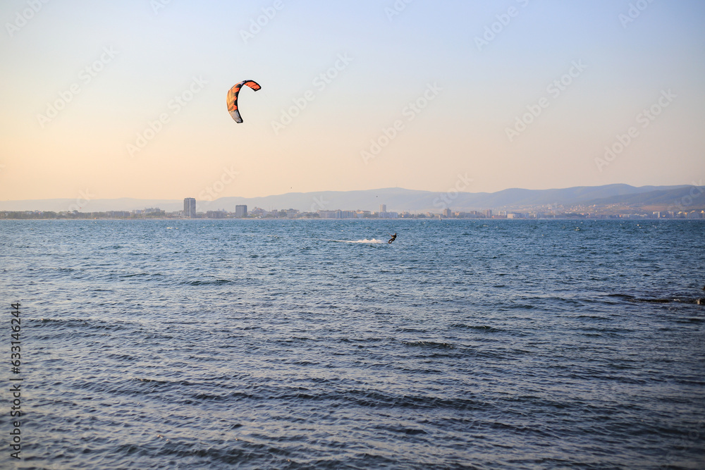 Kiteboarding on the sea at sunset Kiteboarding on the sea at sunset