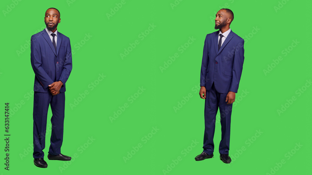 Male entrepreneur having amazed and surprised reaction, feeling stylish in business office suit over full body greenscreen. Corporate employee in awe seeing something in studio. Male entrepreneur having amazed and surprised reaction, feeling stylish in business office suit over full body greenscreen. Corporate employee in awe seeing something in studio.