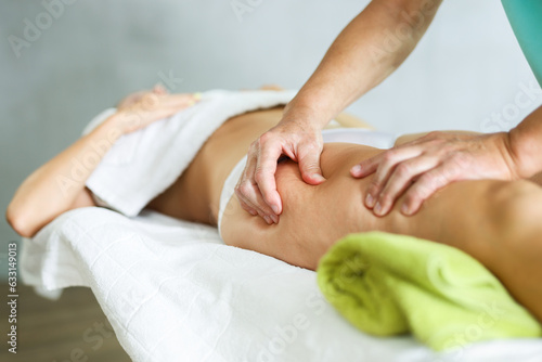 Close-up picture of deep anti-cellulite massage session for female patient.