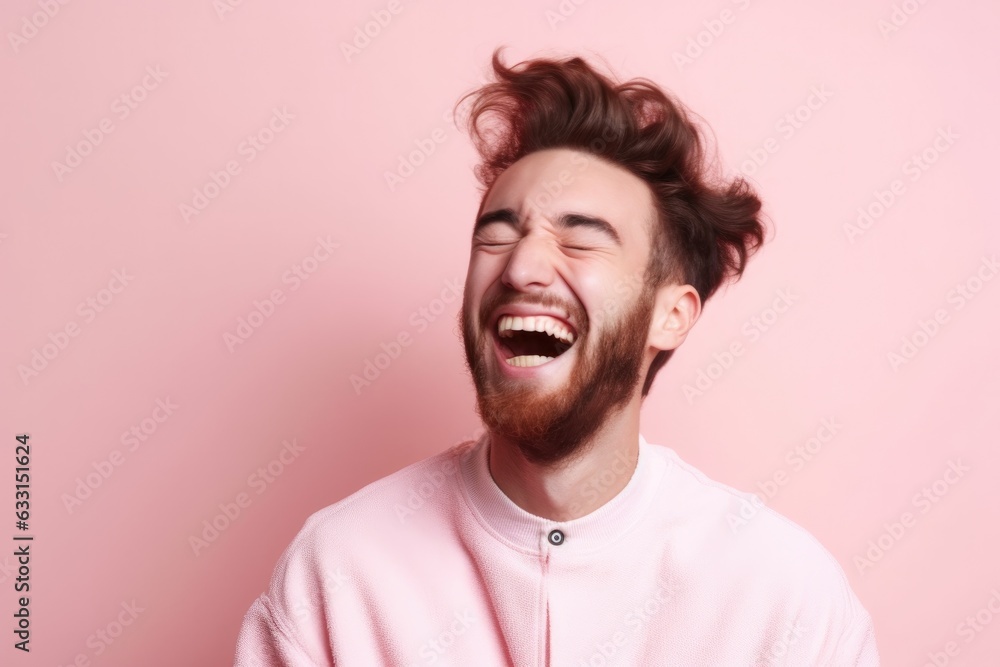 Portrait of a handsome mature man laughing on a plain studio background. Portrait of a handsome mature man laughing on a plain studio background.