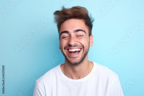 Portrait of a handsome mature man laughing on a plain studio background.