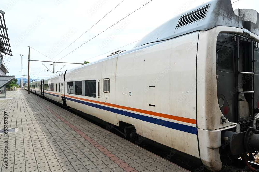 Naklejka premium Passenger train on railway station. Wagons. Transportation. 