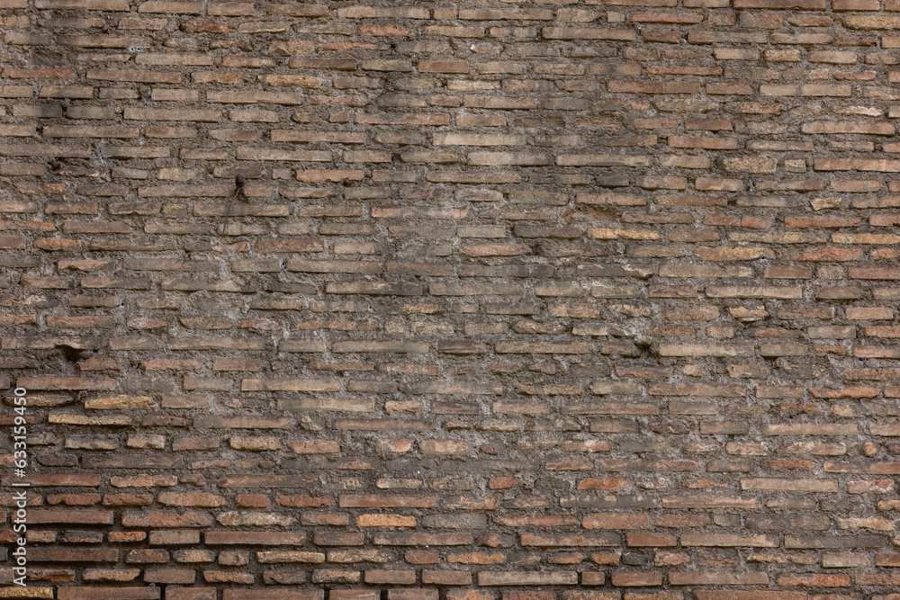 A dark brown old brick European wall in Rome Italy