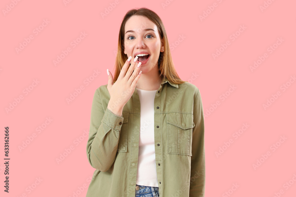 Surprised young woman on pink background Surprised young woman on pink background