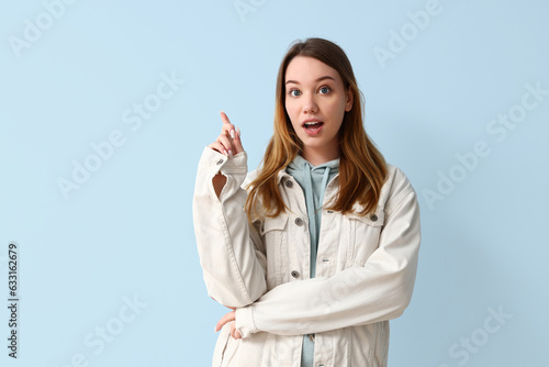 Happy young woman pointing ...