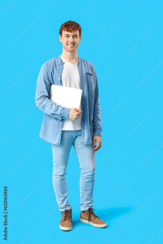 Male programmer with laptop on blue background Male programmer with laptop on blue background