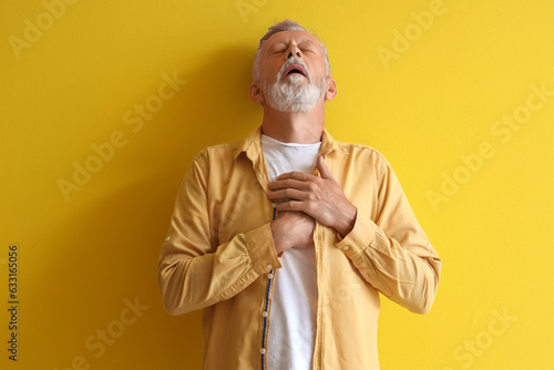 Mature man having heart att...