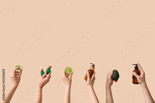 Women with cosmetic products and healthy food on beige background