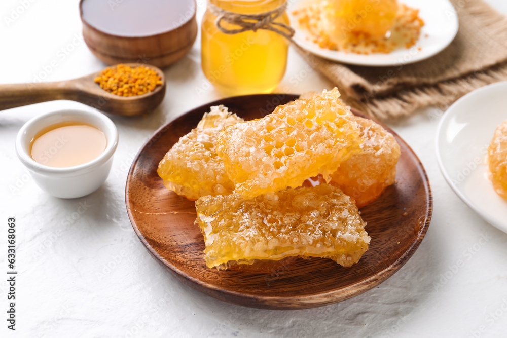 Plate with sweet honeycombs on white background Plate with sweet honeycombs on white background