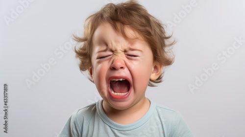 A closeup photo of a cute little baby boy child crying and screaming isolated on white background,
