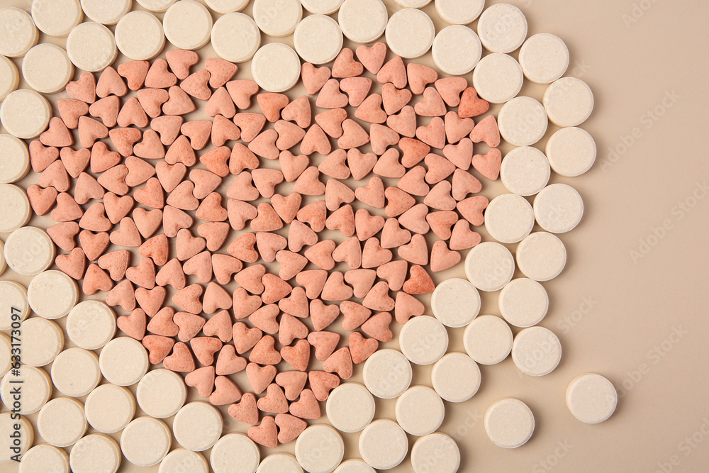 Heart made of vitamins for pets on beige background, flat lay Heart made of vitamins for pets on beige background, flat lay