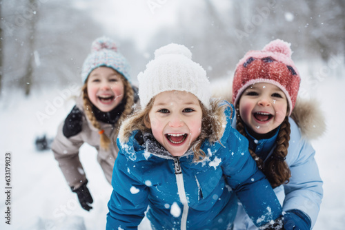 A group of children playing in the snow, laughing and having fun