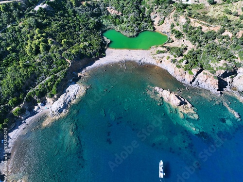 Aerial view of Terranera lake, a pond with emerald green water of sulfur origin between the village of Porto Azzurro and  on Elba Island, Tuscany, Italy photo