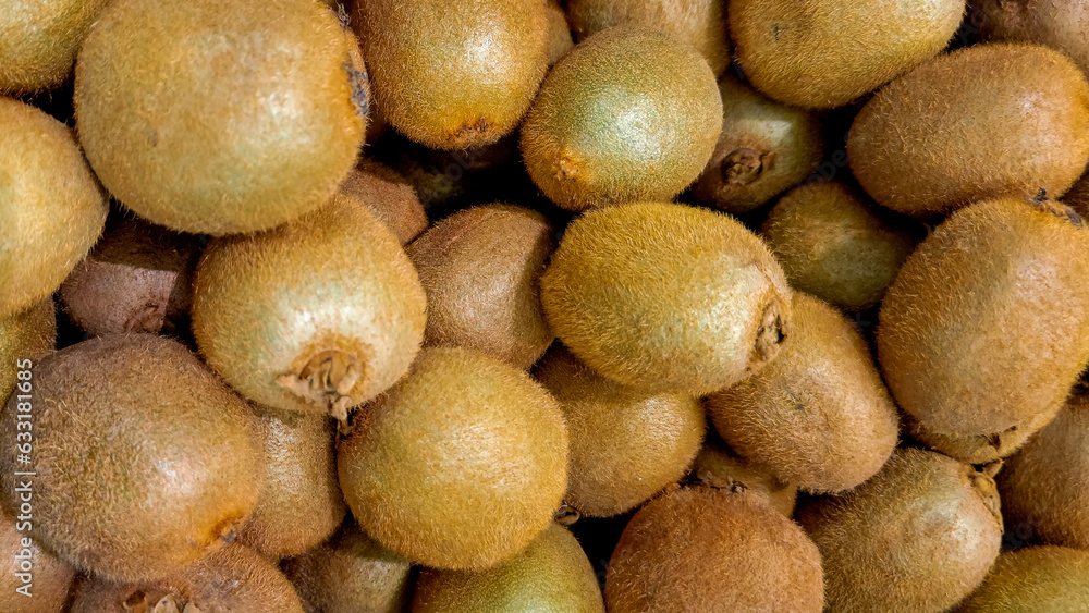 A load of fresh kiwis filling the frame, food or produce background asset. A load of fresh kiwis filling the frame, food or produce background asset.