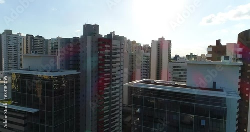 Drone Tilt top of the buildings Londrina Gleba palhano revealing the sun slow photo