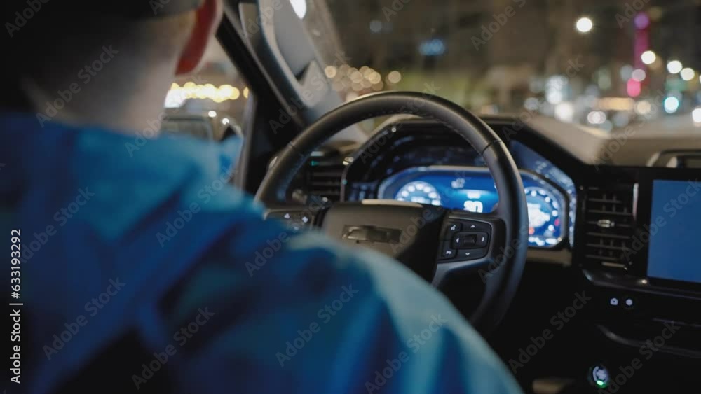 Man driving car through the streets of night city. Man driving car through the streets of night city.