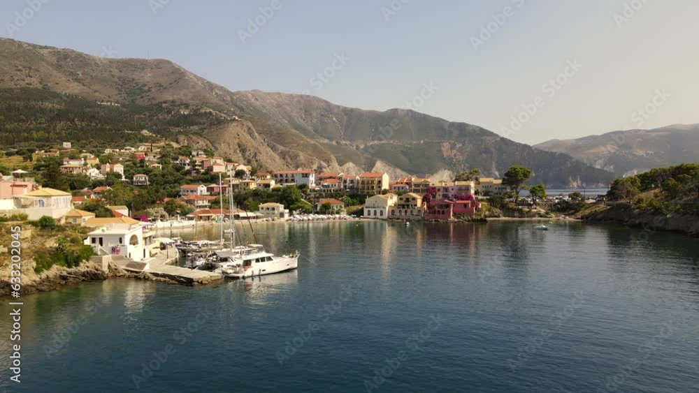 Famous colorful houses on beach Asos in Kefalonia, Greece, aerial sunset dolly Famous colorful houses on beach Asos in Kefalonia, Greece, aerial sunset dolly