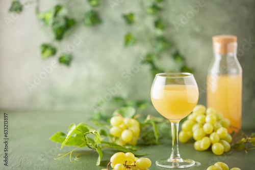 Traditional Czech low alcohol new white wine Burcak, or Neuer Wein,  Vin bourru in wineglasses with grapes bunches photo