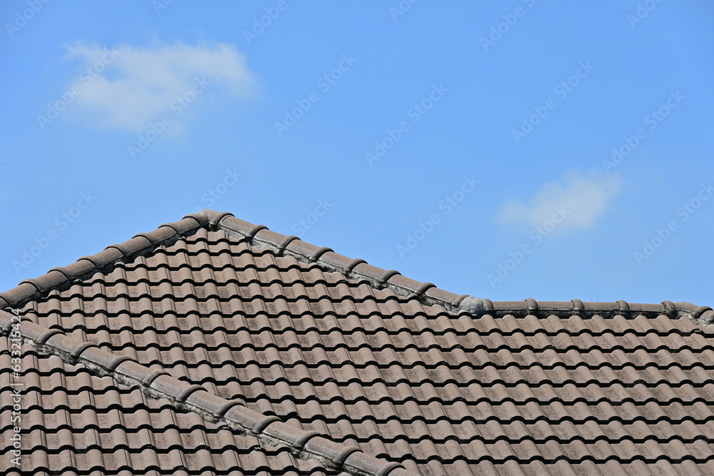 grey roof tile of house on blue sky and white cloud background
