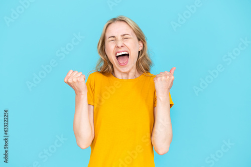 Portrait of emotional screaming woman enjoying success or win photo