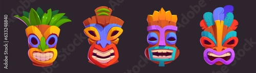 Tiki masks with toothy smile - cartoon vector illustrations set of colorful tribal traditional wooden totems. Images of deities of Hawaiian and Polynesian culture, decorated with leaves and feathers.