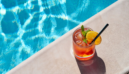 Refreshing cocktail by the pool on a sunny day, the perfect summer vacation. View from above with space for your text