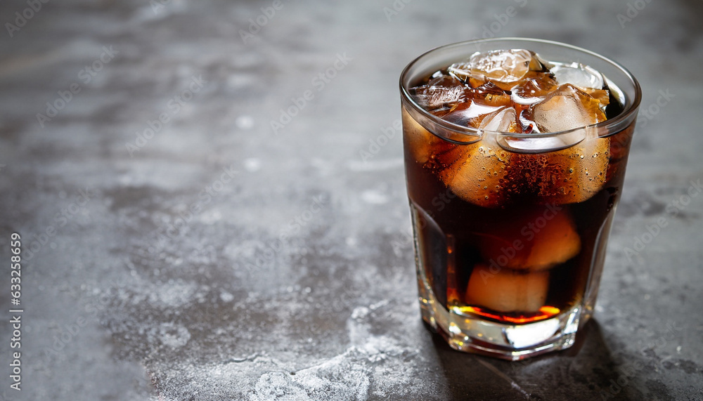 Refreshing glass of cola with ice. On stone table with copy space Refreshing glass of cola with ice. On stone table with copy space