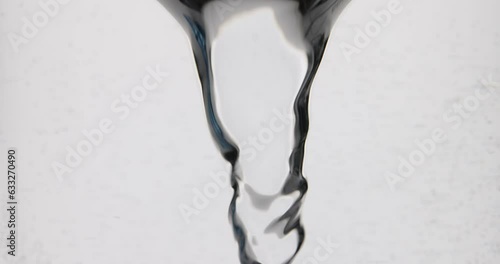 Flow of liquid water swirls into whirlpool or tornado. Fluid flow rotates and forms vortex in slow motion