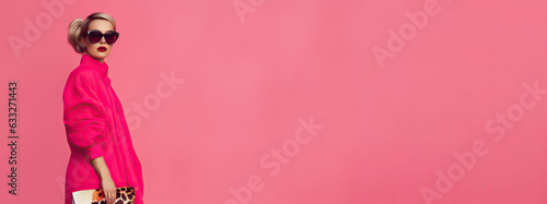 Stylish modern blonde woman wearing pink cloth on pink background, fashion doll, wide web banner