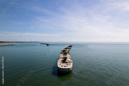 An aerial shot of several abandoned cargo vessels dating back to World War 2 photo