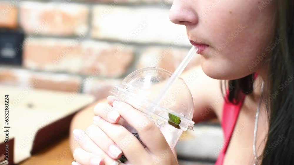 Close-up girl drinks lemonade,thirsty teenage girl. Horizontal 4k footage Close-up girl drinks lemonade,thirsty teenage girl. Horizontal 4k footage
