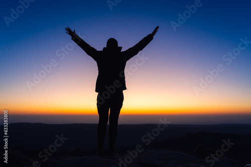 silhouette of person with arms outstretched