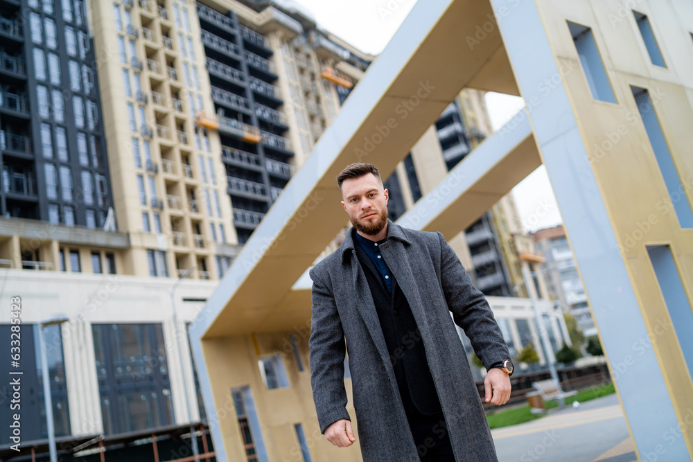Man standing in front of a towering skyscraper Man standing in front of a towering skyscraper