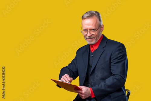 Businessman holding a folder in a professional setting. A man in a suit is holding a folder