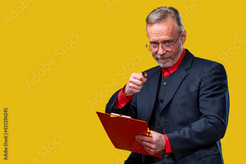 Businessman holding a red folder. A man in a suit holding a red folder