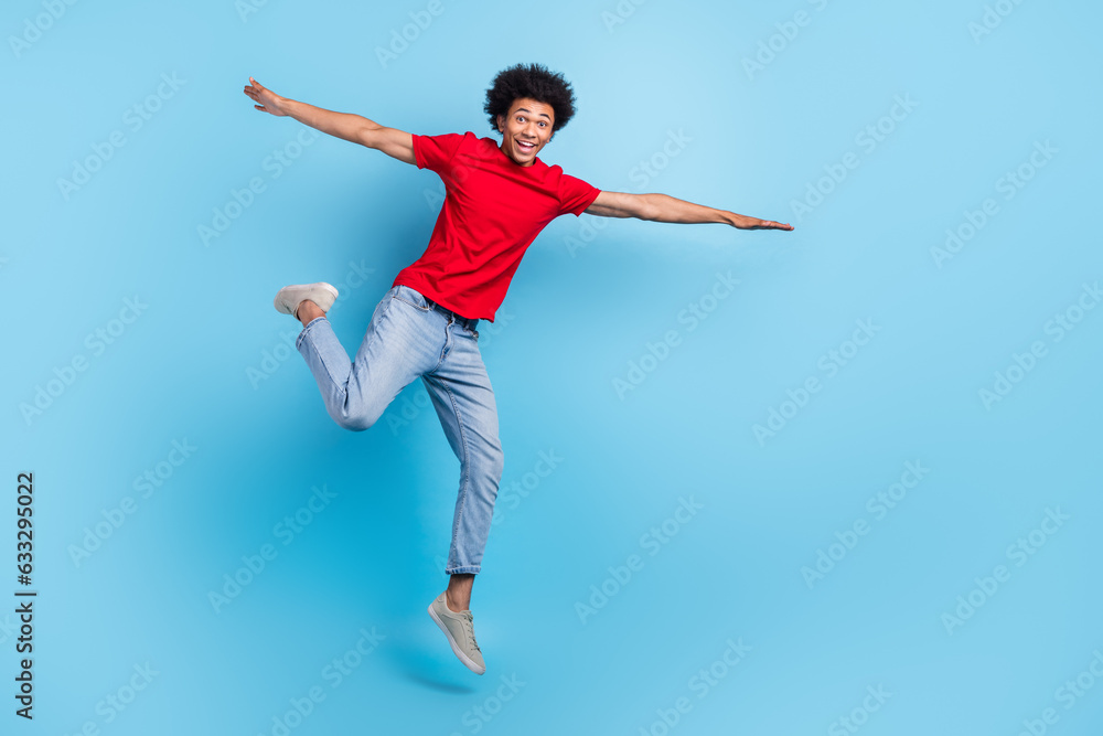 Full body photo of jumping flying wings hands youngster guy feel free summer holidays no university isolated on blue color background